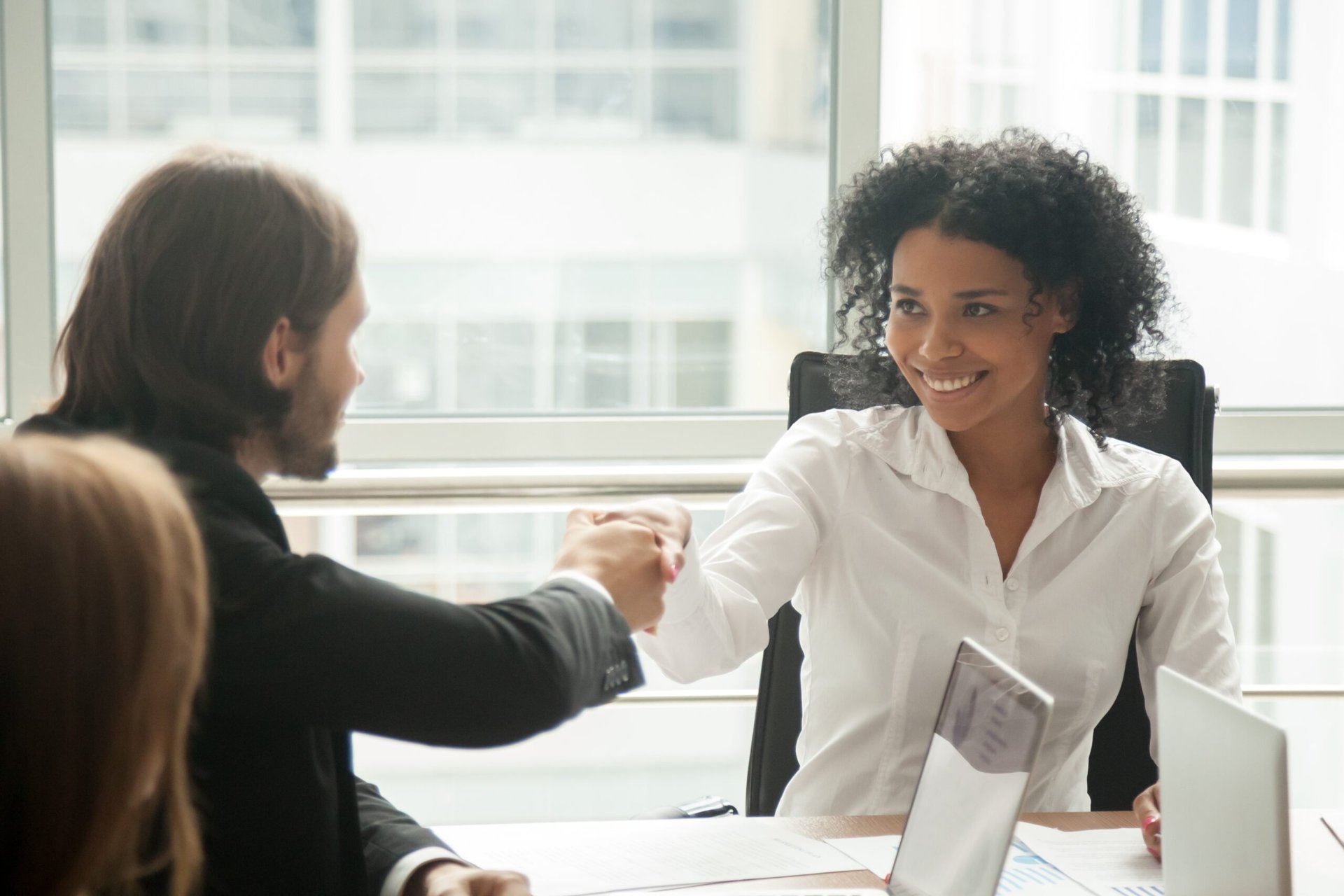 Man and woman shaking hands for a new job or employee hire
