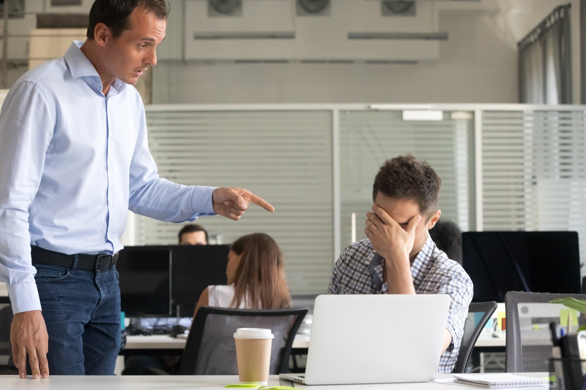 Boss pointing and scolding or reprimanding employee