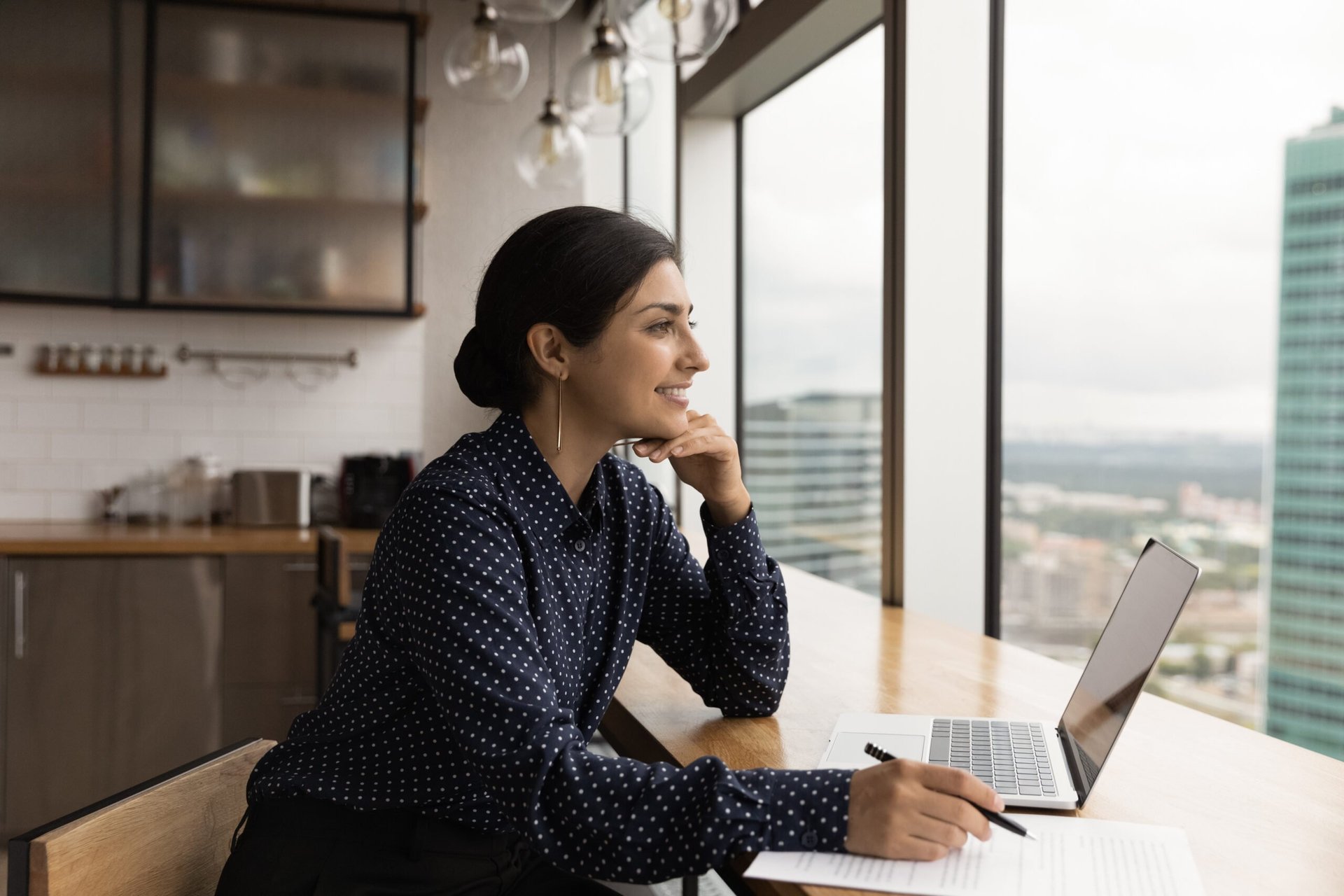 Woman working from home in a high-rise building