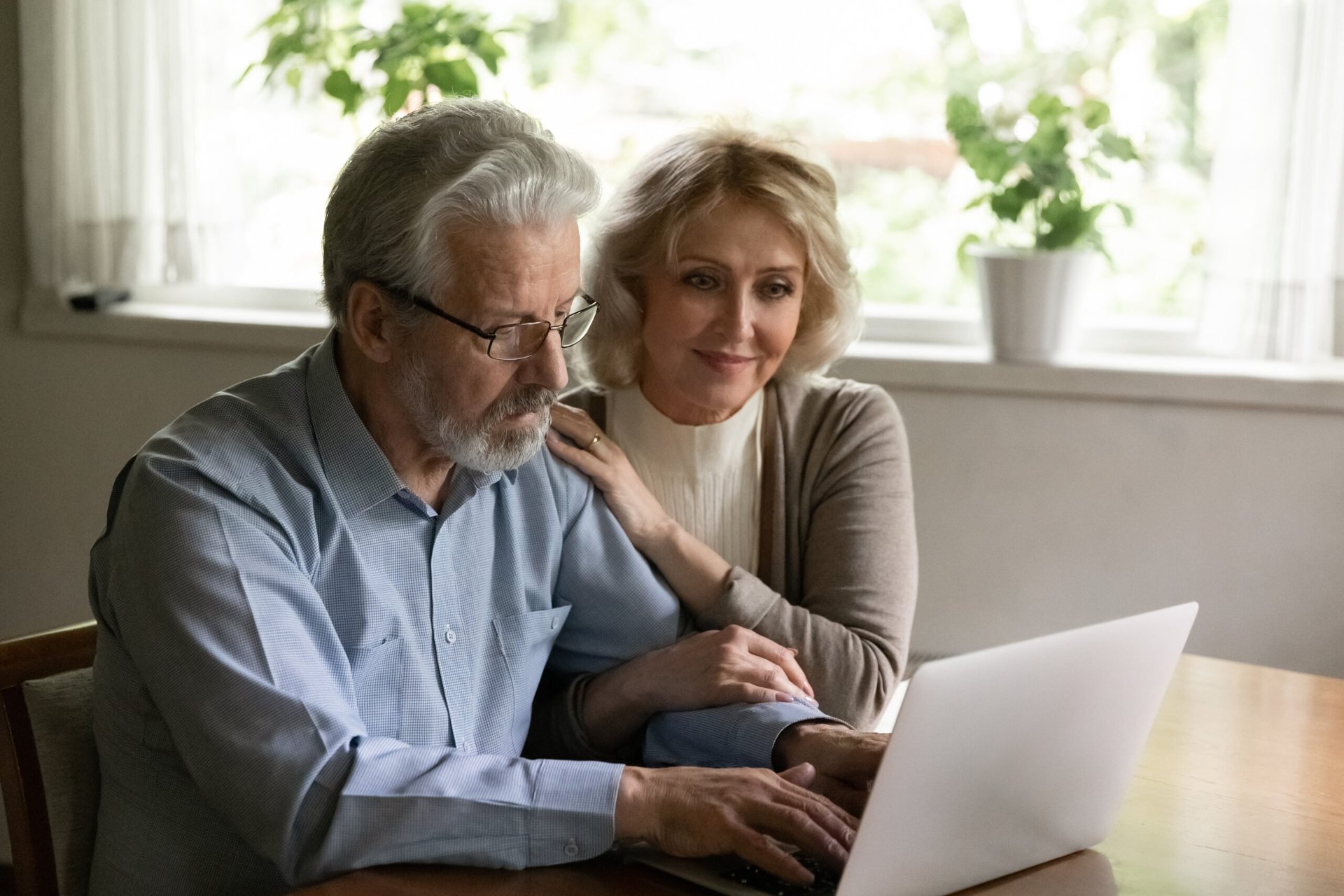 Older couple looking content at computer.