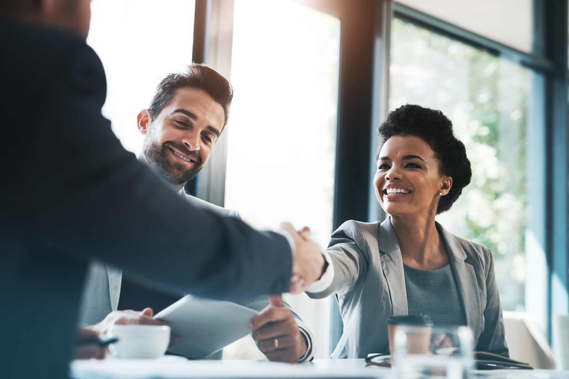 Woman shaking hands at job interview.